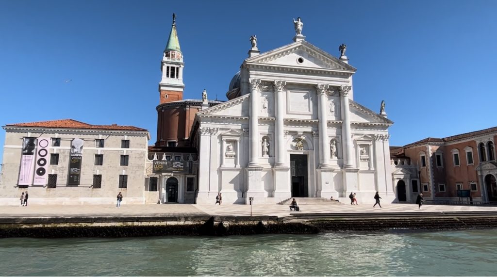 The front of the white Chiesa San Giorgio Maggiore in Venice with water in the foreground